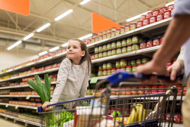 child-with-father-buying-food-at-grocery-store