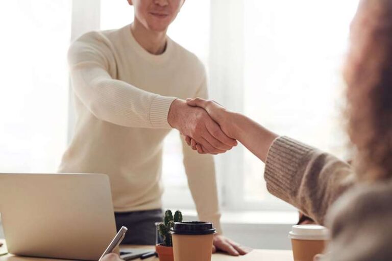 man-and-woman-handshake-near-table